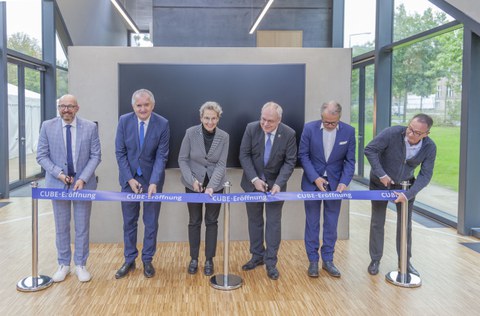 6 Personen zerschneiden ein Eröffnungsband.