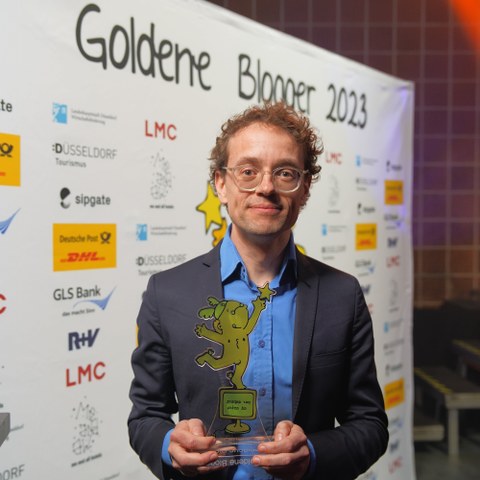 Photo of Prof. Simon Meier-Vieracker with his trophy at the Golden Blogger Awards