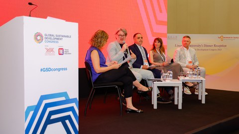 Photo of five people on a stage of a panel at the Global Sustainable Development Congress. The second person from the left is André Lindner from TU Dresden.
