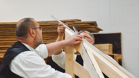 Carpenters working with wood.