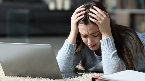 Woman sad in front of a loptop