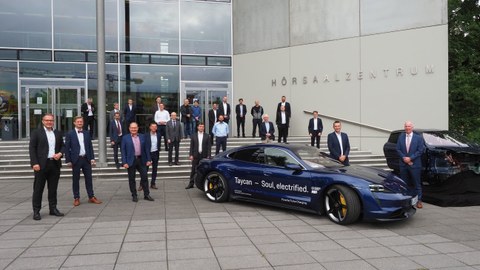 Vertreter der Porsche AG und der TU Dresden sowie Gästemit Porsche Taycan (vorn li.) inklusive Schnellladesystem sowie Cockpit