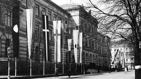 Die Alte Hochschule am Bismarckplatz mit Fahnen.