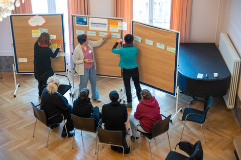 Von oben Anischt Teilnehmende in Austausch an Tafel