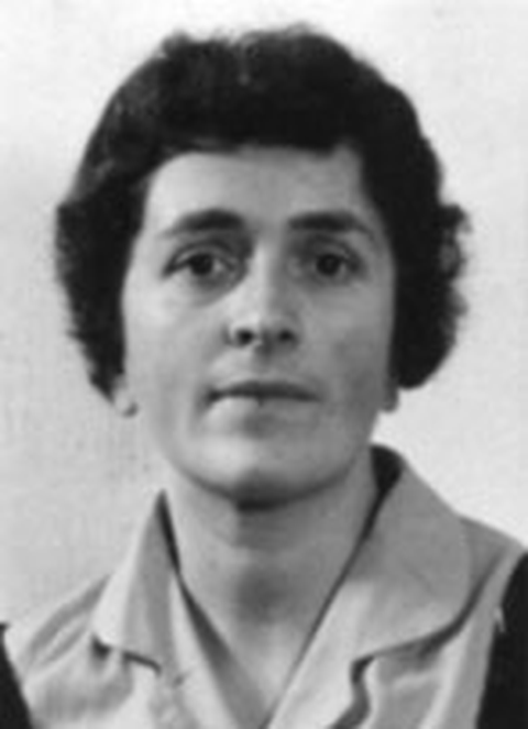Portrait photo of a woman with short dark hair and a serious expression, in black and white.