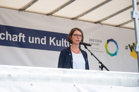 Roswitha Böhm steht auf einer Bühne und spricht.