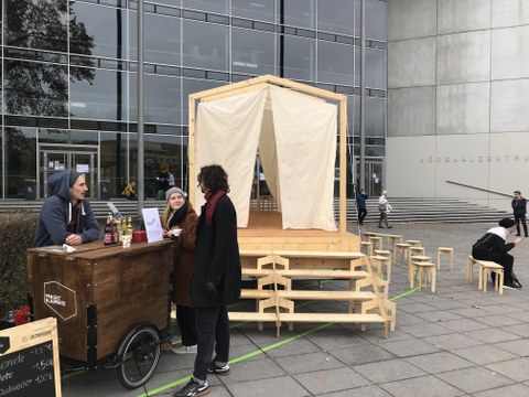 Fahrzeuganhänger mit Holz und Tüchern, der als mobile Kapelle fungieren soll