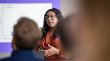 A student is presenting. In the front is the blurry audience.