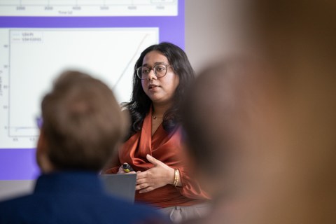 A student is presenting. In the front is the blurry audience.