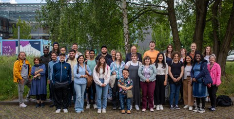 Gruppenbild mit ca. 30 Personen vor einem Baum.