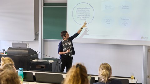 Frau hält Vortrag in einem Seminarraum