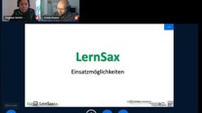 Screenshot von einer BigBlueButton-Videokonferenz: Abbgebildet zwei Moderator:innen einer Online-Fortbildung zu LernSax. Man sieht ebenso eine LernSax-Folie im unteren-Bildbereich