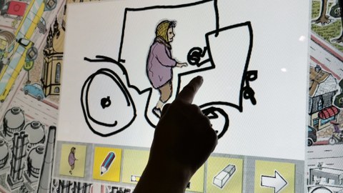 Bild einer Grafik auf einem Touchscreen, auf dem eine Person mit ihrem Finger etwas malt.